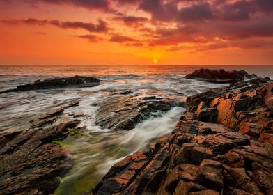 Sunset on lake sea rock