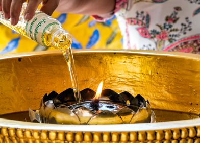 Woman lighting an oil cand