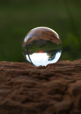 Glass ball on rock