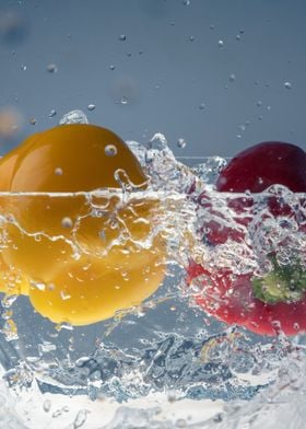 Peppers splashing in water