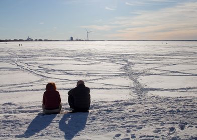 Couple Sitting On Snow