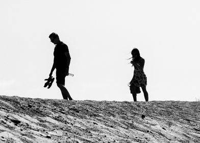 Couple Walking On The Sand
