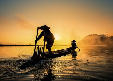 Asian fishermen on boat fi