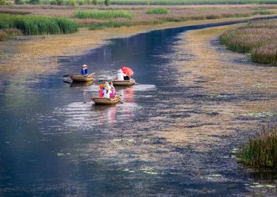 Tourists and bamboo boats