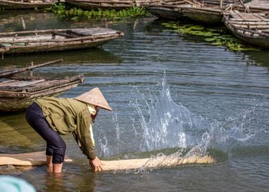 Washing sedge mat on lake