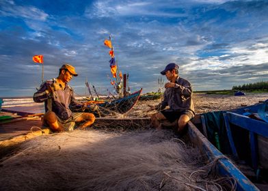 Fishermen repairing nets