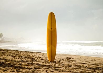 Yellow surfboard alone