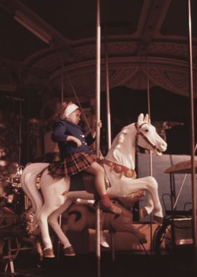 Girl riding on a carousel