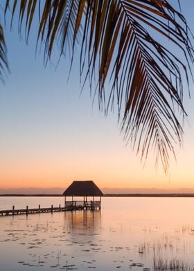 Pier and hut at sunset