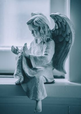 White angel on window sill