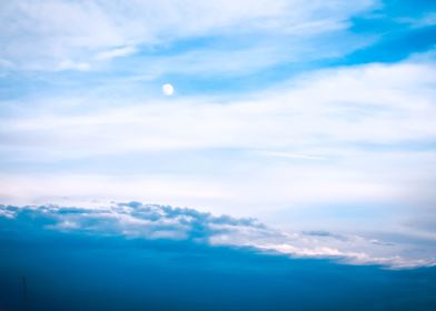 Daytime moon in the clouds