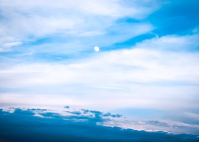 Daytime moon in the clouds