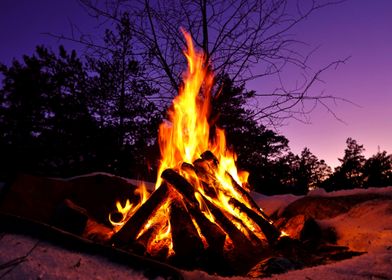 Campfire flames in sunset