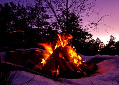 Campfire flames in sunset