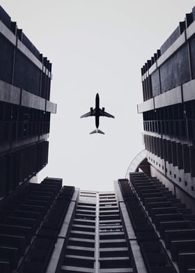 Airplane above buildings