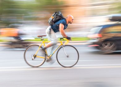 Man riding yellow bicycle 