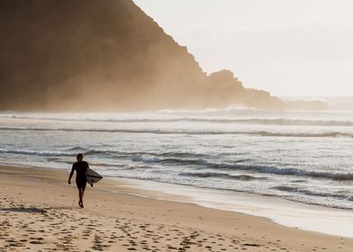 Solo surfer on the beach