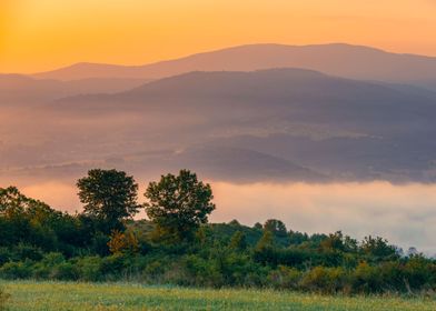 Misty sunrise in mountains