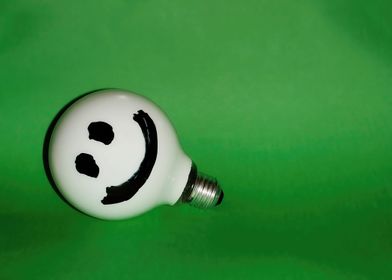 White smiling bulb on gree