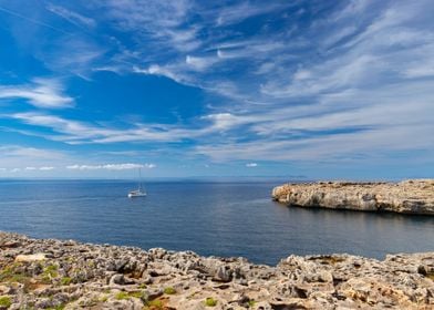 White sailboat in blue sea