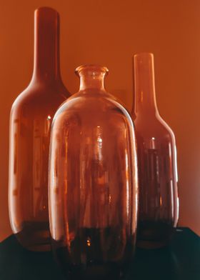 three orange glass vases