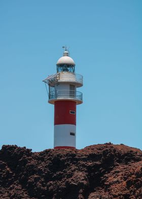 Lighthouse and Rocky Shore