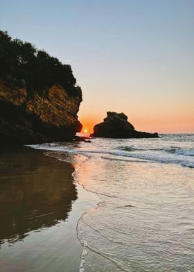 a beach with a sunset