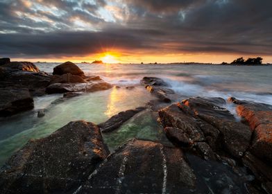 rocky shore under cloudy