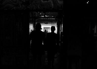 Silhouettes in a Dark Hallway