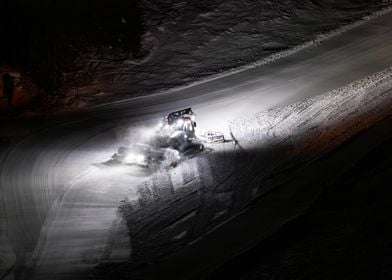 Snowcat Grooming Slopes at Night