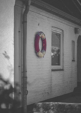 Lifebuoy on Brick Wall