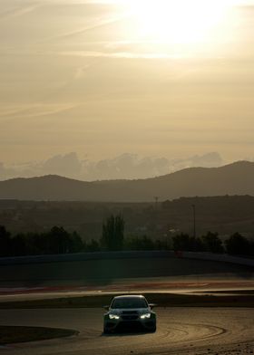 Race Car on Track at Sunset