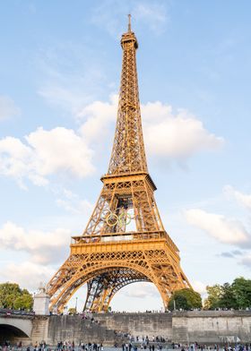 Eiffel Tower with Olympic Rings, view from Seine river on sunset.