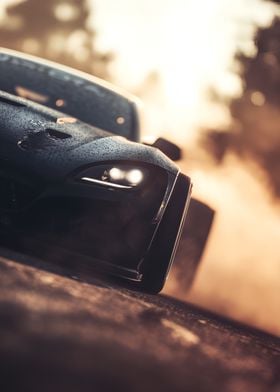 Black Sports Car speeding out of a cloud of smoke, Close-Up