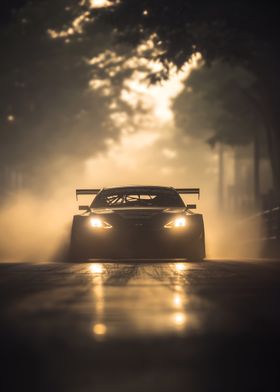 black racing car drifting out of a cloud of smoke