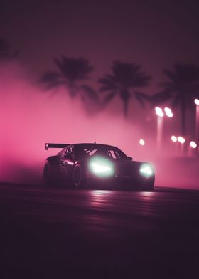 black racing car speeding out of a cloud of smoke