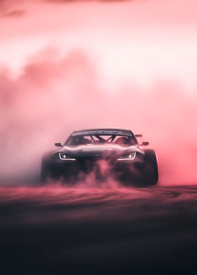 black racing car speeding out of a cloud of smoke