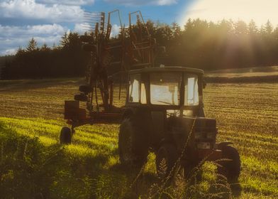 Tractor in Field at Sunset