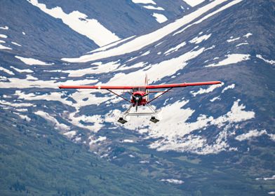 Red Seaplane Over Mountains