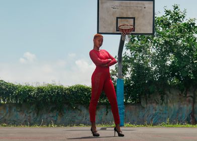 Woman in Red Jumpsuit on Basketball Court