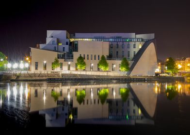 Modern building by water at night, Conservatory of Strasbourg, Alsace, France