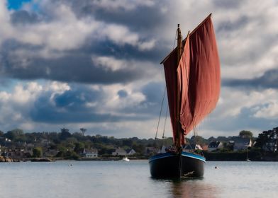 Sailboat Under Cloudy Sky