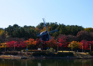 Windmill in Autumn Landscape