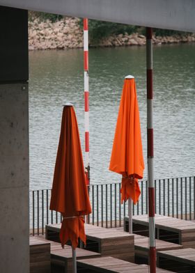 Orange Umbrellas by the Water