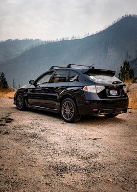 Black Subaru WRX in Wildfire Mountains