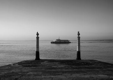 Ferry And Columns Pier In Lisbon