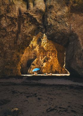 Beach Cave with Blue Umbrella