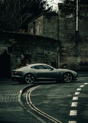 Grey Jaguar on Cobblestone Street