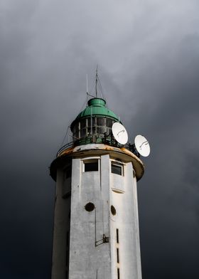 Lighthouse Under Storm Clouds