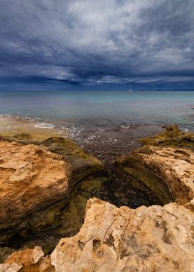 Rocky Coastline Under Stormy Sky